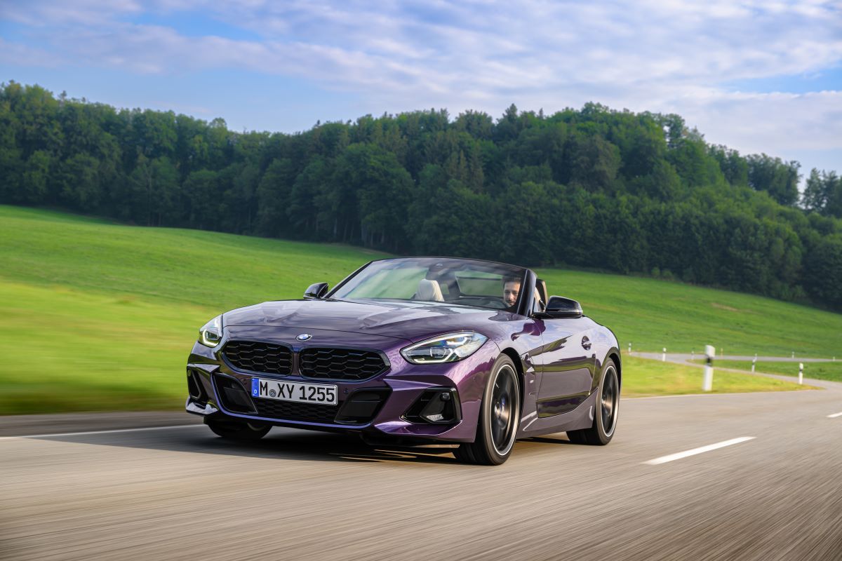 A purple 2023 BMW Z4 Roadster driving on a road