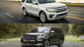 A white 2023 Ford Expedition and a black 2023 Lincoln Navigator