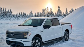 A white 2023 Ford F-150 Lightning in the snow.