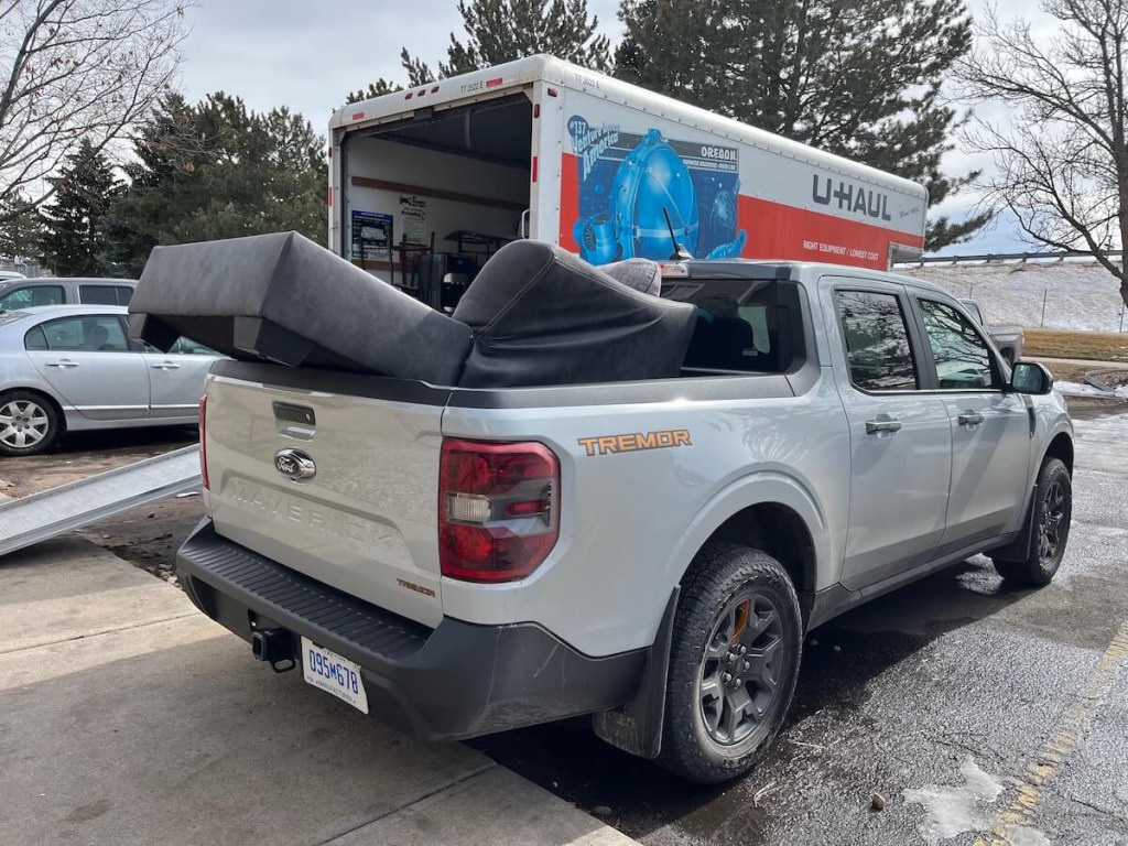 A Ford Maverick Tremor shows off its usability by hauling a couch. Ford Maverick recalls haven't impacted hauling items.