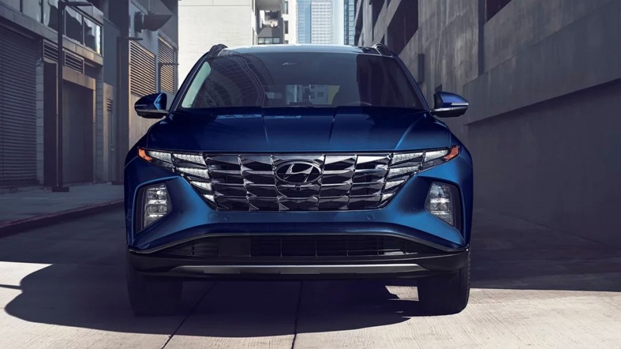 A blue 2023 Hyundai Tucson Hybrid small hybrid SUV is parked.