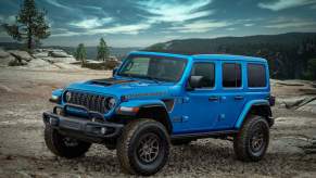 A blue 2023 Jeep Wrangler parked outdoors.
