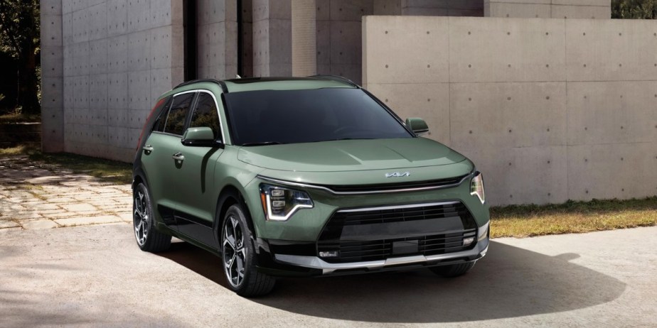 A green 2023 Kia Niro subcompact SUV is parked.
