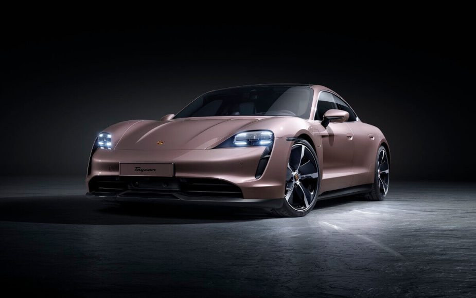 A lightly-colored 2023 Porsche Taycan luxury electric car poses for a picture.