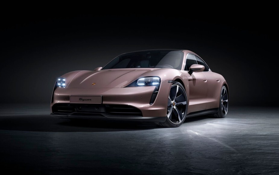 A lightly-colored 2023 Porsche Taycan luxury electric car poses for a picture. 