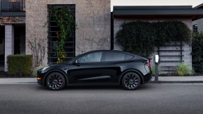 A black Tesla Model Y small electric SUV is parked.