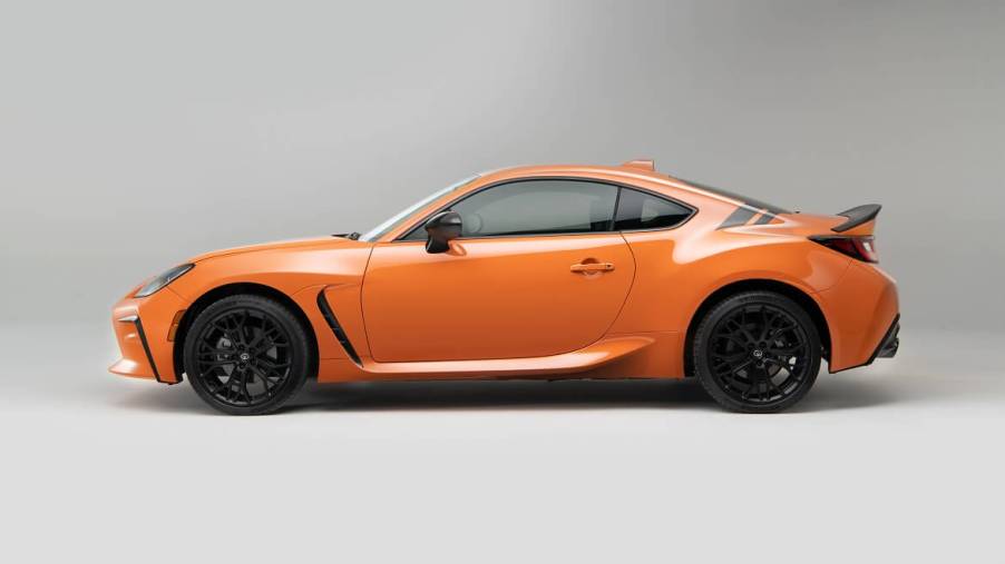 The 2023 Toyota GR86 shows off its problem-free design and orange paintwork.
