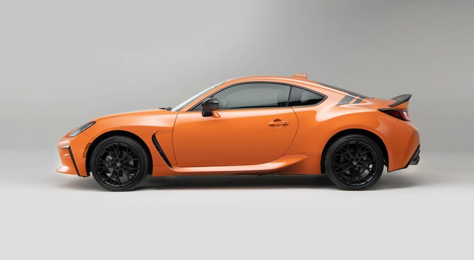 The 2023 Toyota GR86 shows off its problem-free design and orange paintwork.