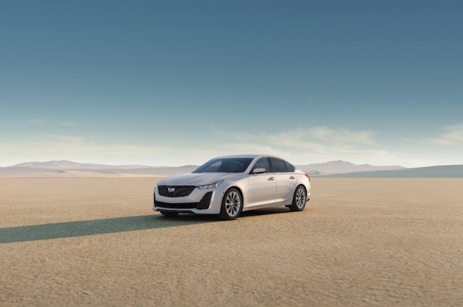 The properly fast Cadillac CT5-V sedan shows off its white paintwork and luxury car profile in the desert. 