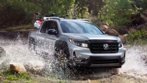 The 2023 Honda Ridgeline drives through water as a mid-size truck.