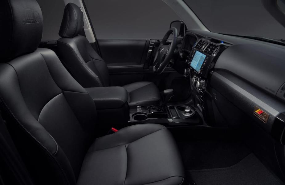 The black leather interior of a 2023 Toyota 4Runner SUV with 4WD and a 3rd-row of seating.