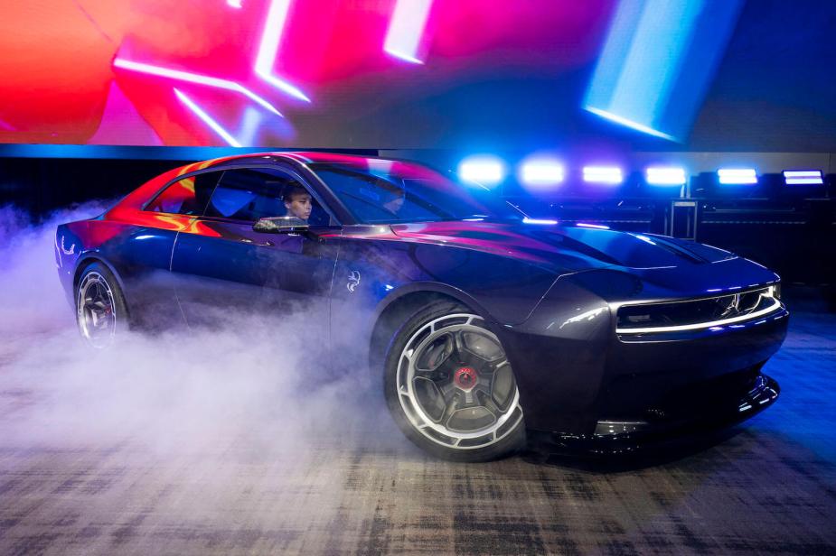 The new electric Charger Daytona SRT concept coupe driving across a Detroit stage for its debut by Dodge.