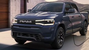 A blue 2025 Ram 1500 REV electric pickup truck is charging.