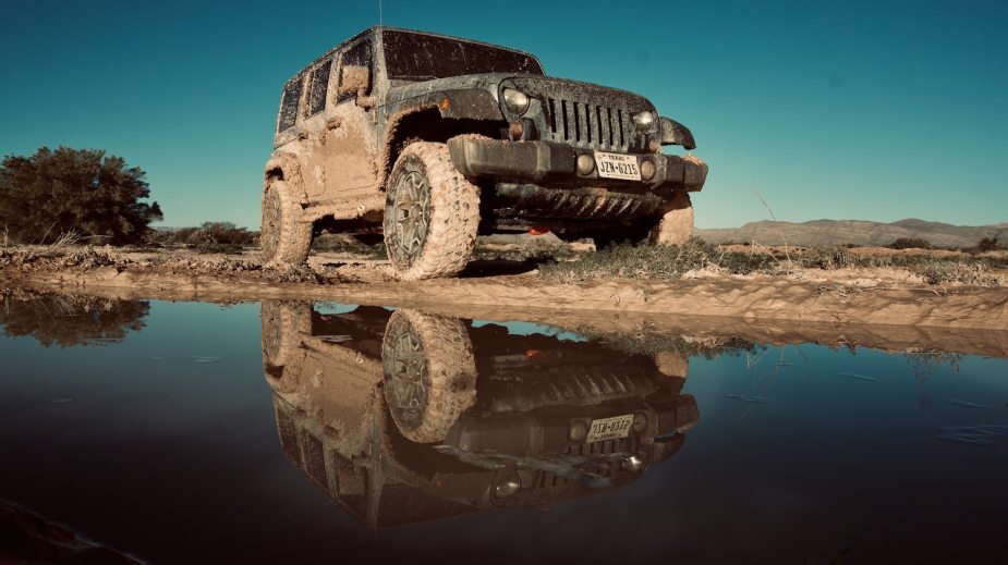 Jeep Wrangler covered in mud while off-roading