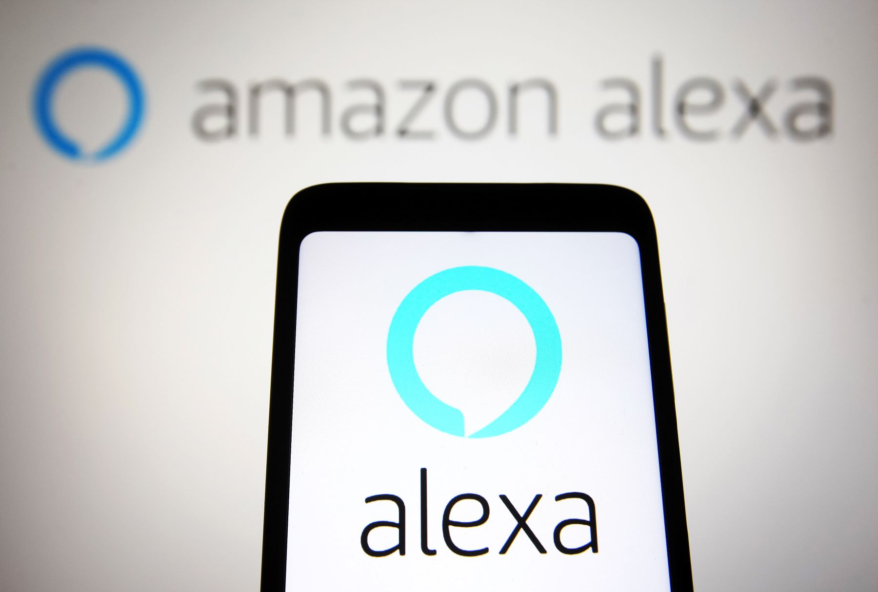 An Amazon Alexa graphic on a smartphone and in the background