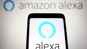 An Amazon Alexa graphic on a smartphone and in the background