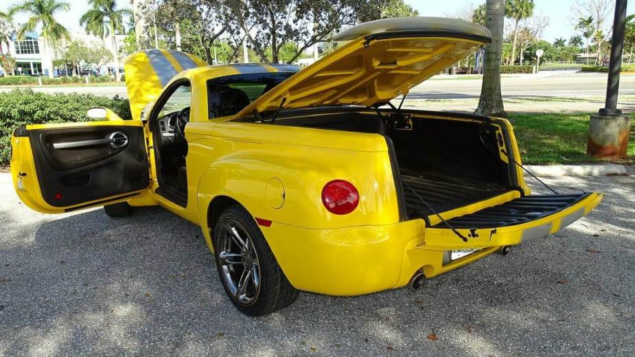 Rear 3/4 View of a Yellow Chevy SSR With All Doors Open
