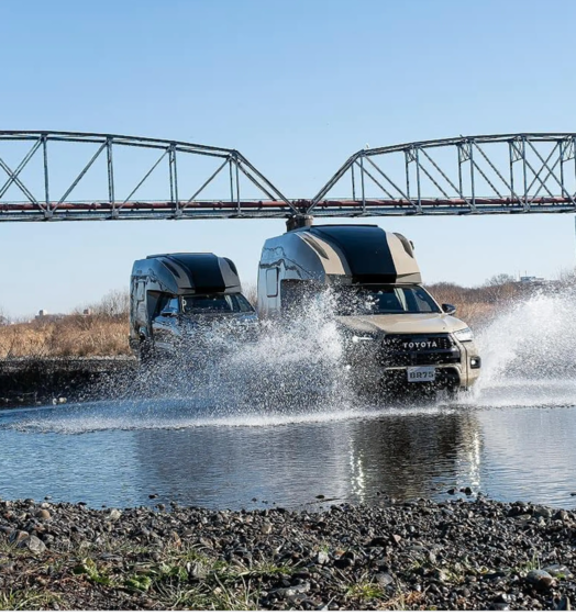 Direct Cars Toyota Hilux Camper splashing through a river