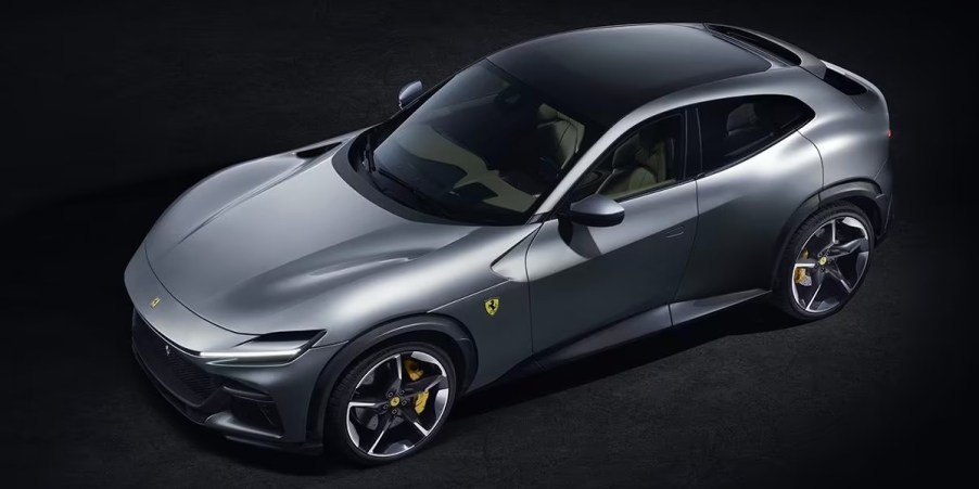 A gray Ferrari Purosangue luxury sports SUV is parked.