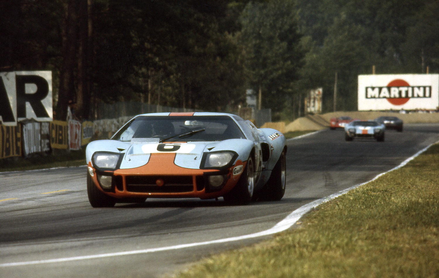 Le Mans 24 Hours 15th June 1969. Two blue and orange GT40s on a straightaway, other cars in the background: Jacky Ickx/Jackie Oliver, Ford GT40, race winner. Car no 7 in background David Hobbs/Mike Hailwood, Ford GT40, finished 3rd.  