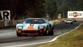Le Mans 24 Hours 15th June 1969. Two blue and orange GT40s on a straightaway, other cars in the background: Jacky Ickx/Jackie Oliver, Ford GT40, race winner. Car no 7 in background David Hobbs/Mike Hailwood, Ford GT40, finished 3rd.