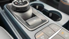 The electronic parking brake button in a Ford Maverick