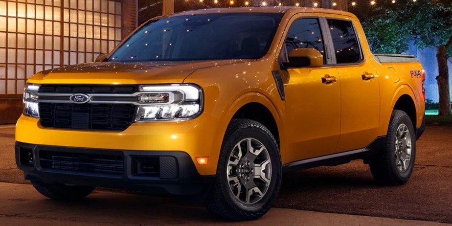 A yellow 2023 Ford Maverick small pickup truck is parked outdoors.