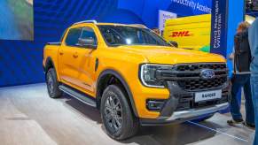 A yellow Ford Ranger parked indoors.