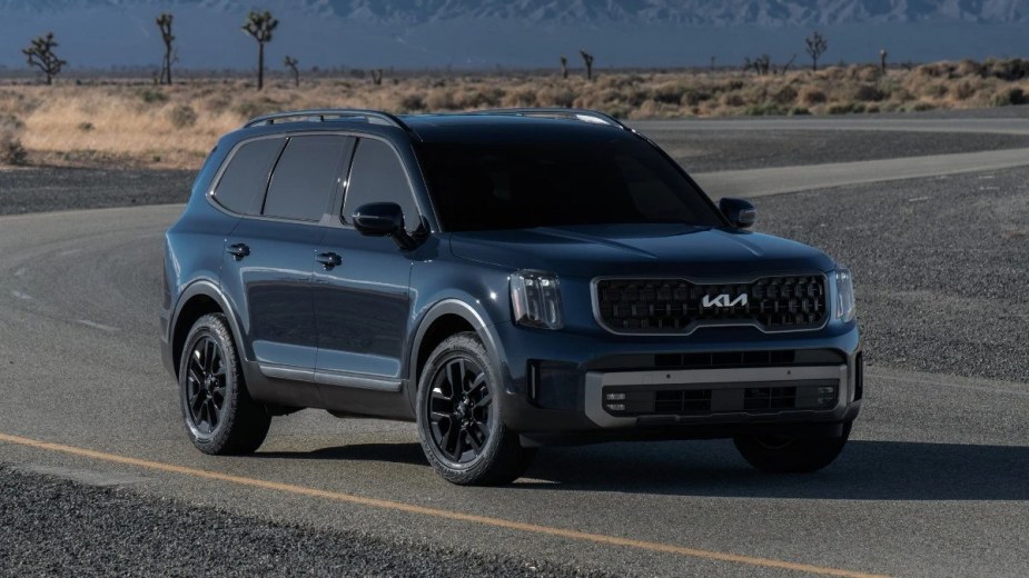 Front view of the blue 2023 Kia Telluride, according to Car and Driver the best new 2023 mid-size SUV to buy