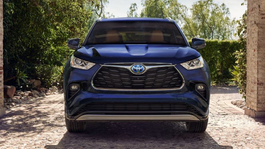 Front view of blue 2023 Toyota Highlander, parked in a driveway
