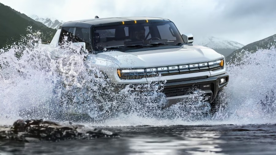 A 2023 GMC Hummer EV drives through water, it might be one of the most expensive trucks in 2023.