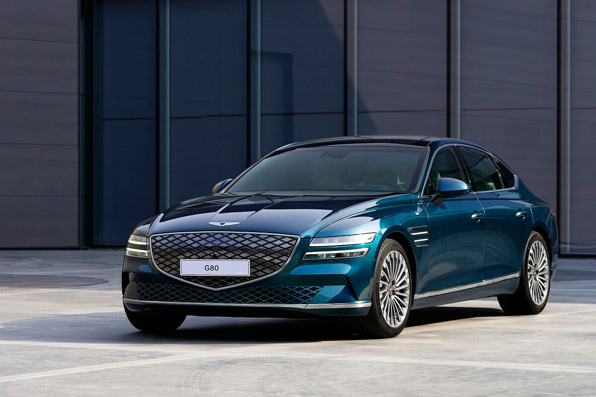 A Genesis Electrified G80 shows off its blue green paintwork.