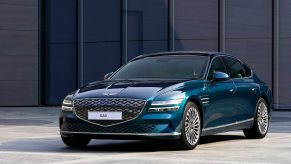 A Genesis Electrified G80 shows off its blue green paintwork.