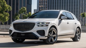 A white Genesis GV70 parked on display.