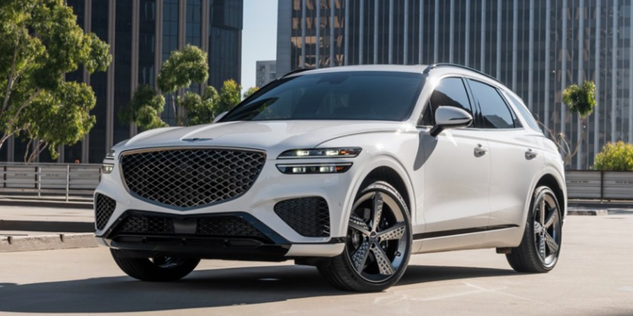 A white 2023 Genesis GV70 small luxury SUV is parked.
