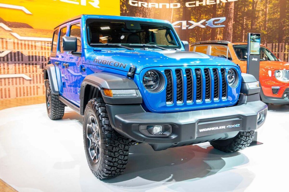 A blue Jeep Wrangler parked indoors. 