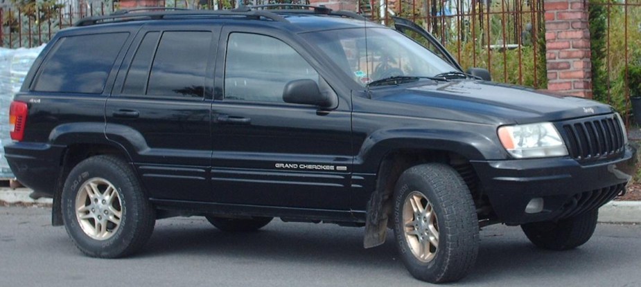 A WJ Jeep sits on the side of the road.