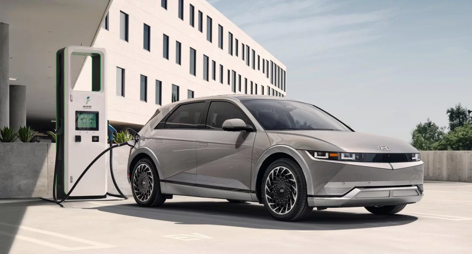 A gray 2023 Hyundai Ioniq 5 small electric SUV is parked and charging. 