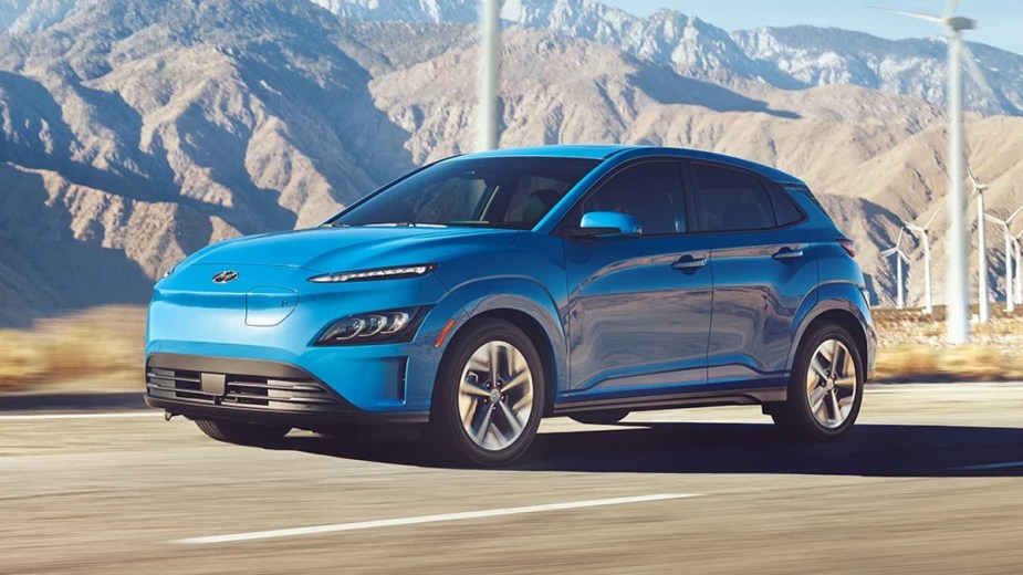 Blue Hyundai Kona Electric with mountains in the backgroun