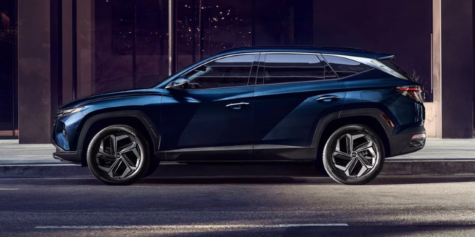 A blue 2023 Hyundai Tucson Hybrid small SUV is parked.