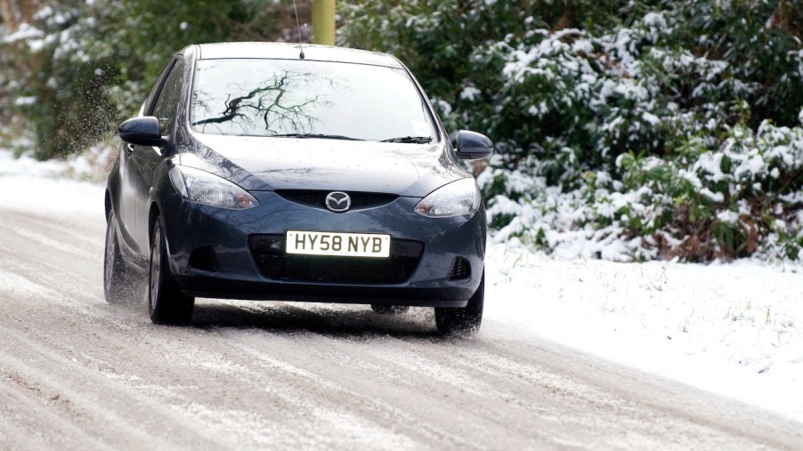 Mazda2 driving on snowy road.