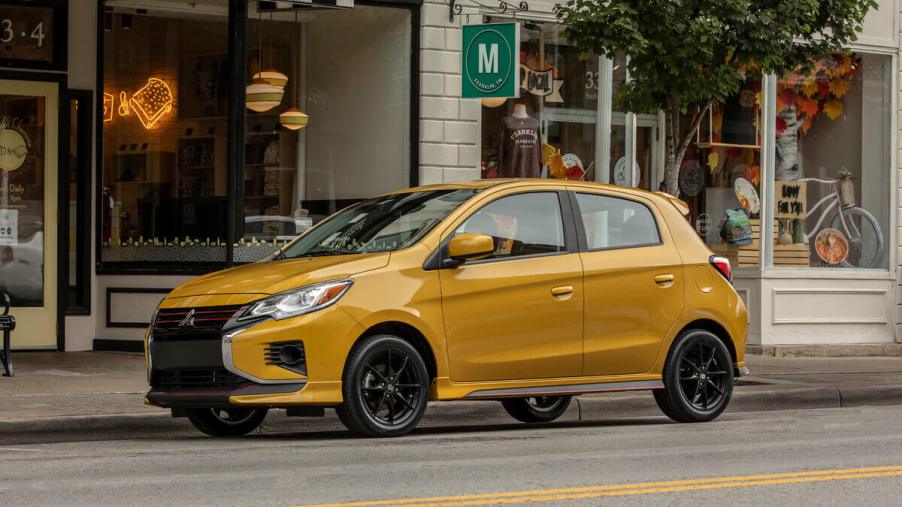 The cheapest car in the automaker's lineup, a 2023 Mitsubishi Mirage sits outside a restaurant.