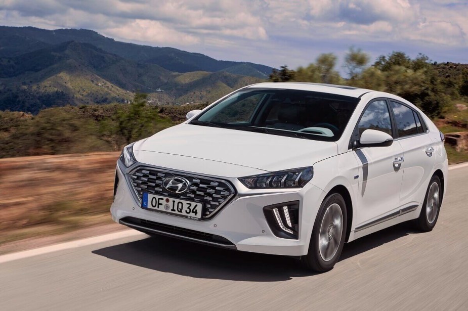 Complete with standard safety features, a 2022 Hyundai Ioniq shows off its white paintwork and hatchback styling. 