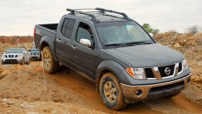 A Nissan Frontier drives on a trail, it has some complaints on RepairPal. Some of the common Nissan Frontier problems are worrisome.