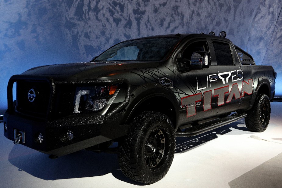A diesel Nissan Titan XD is featured at an auto show. It comes with a Cummins turbodiesel engine.