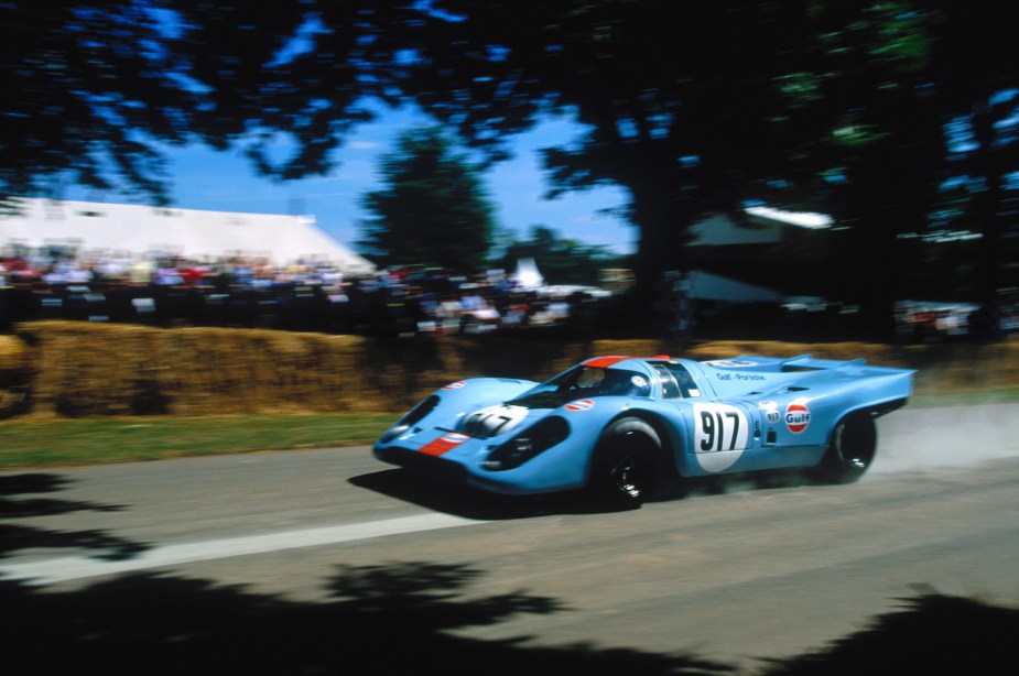 Porsche 917K wearing Gulf liveries, a crowd visible in the background.