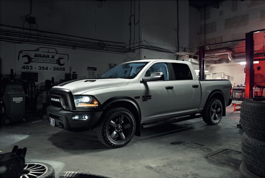 A fourth-generation Ram 1500 pickup truck parked in a garage for a coolant leak issue.