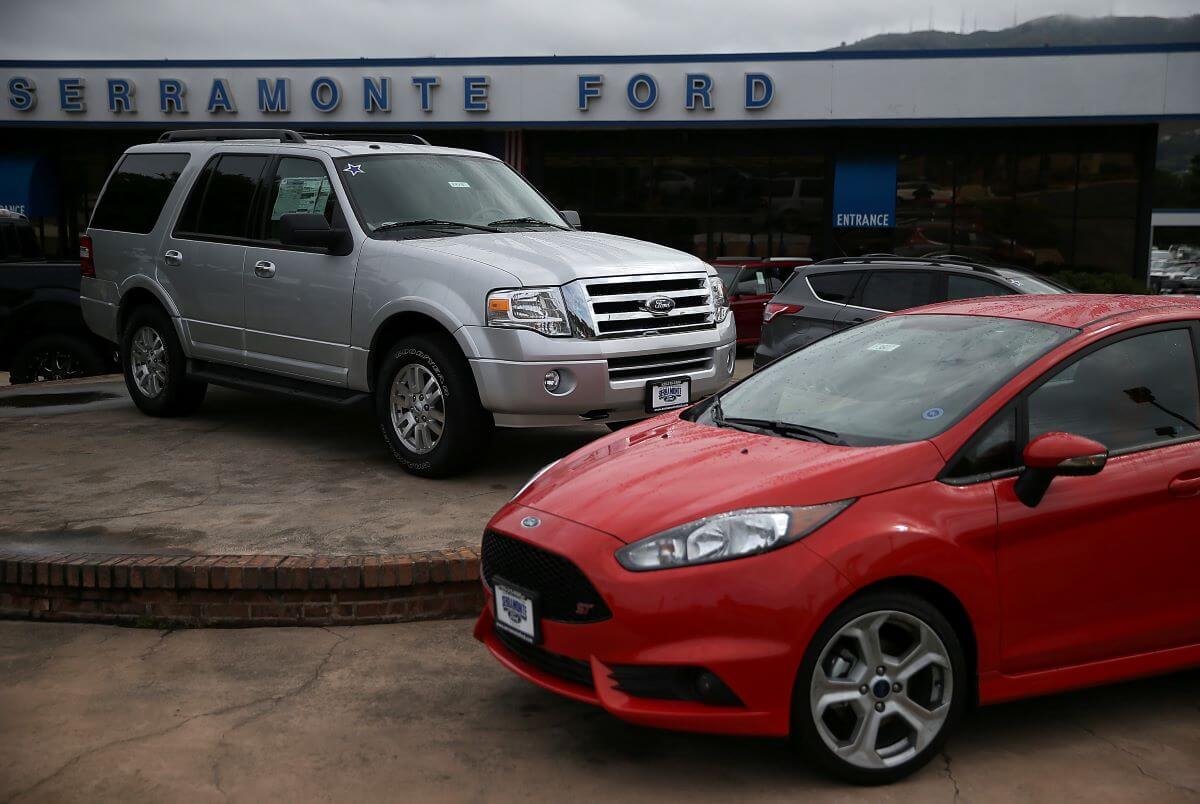 A Ford SUV and sedan on display at the Serramonte Ford dealership in Colma, California