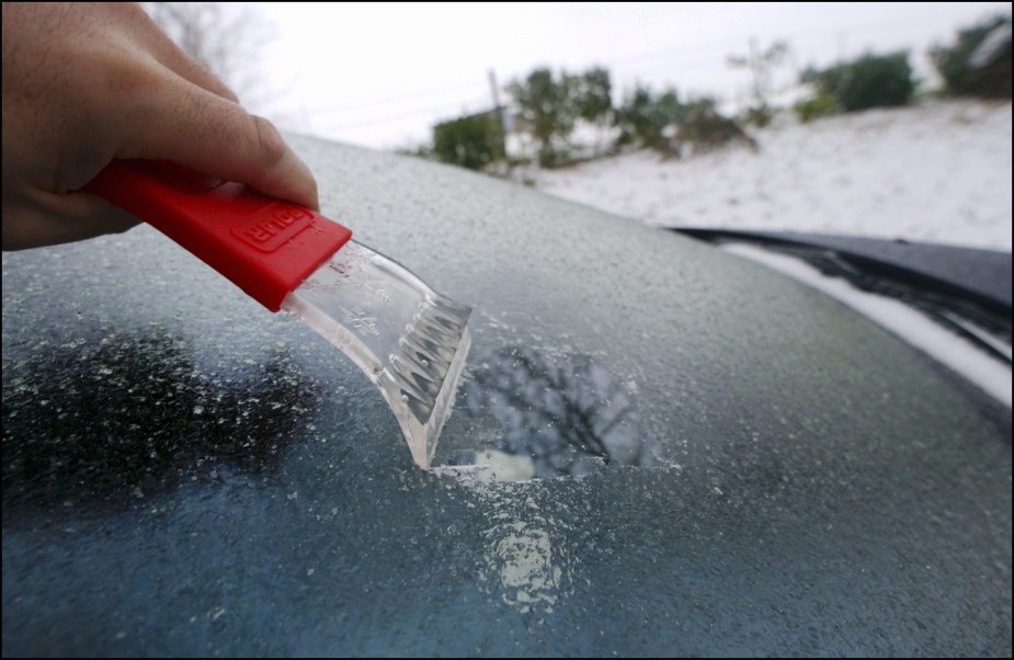 A frozen windshield covered in ice can be defrosted in ways without defrosters