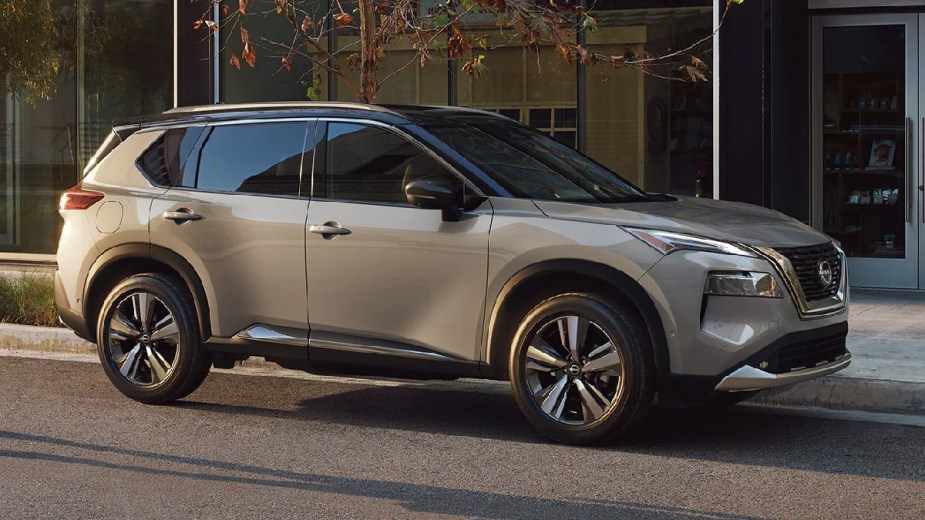 Side view of beige 2023 Nissan Rogue crossover SUV